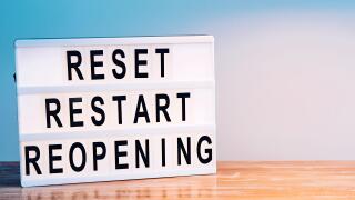 Words reset, restart and reopening on the light box. New life, new business, new deals concept