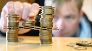 stacking gold dollar coins into bridge using a cantilever 