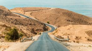Long desert road stretching. empty asphalt road in the middle of the desert with the nature of the middle East