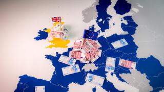 EU and UK flags,euro and pound bills on a european map with EU members in blue.Suitable for a concept of BREXIT,pound against euro,London or Frankfurt