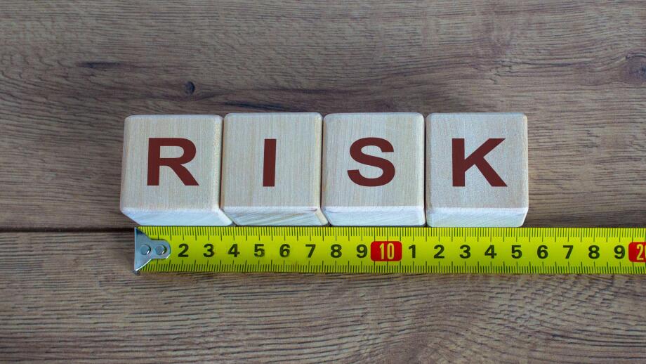 Risk Word On Blocks Arranged Behind The Ruler On Wooden Table