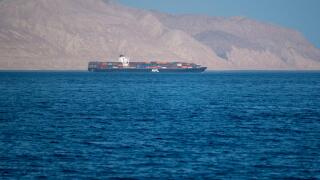 Bukha, OMAN - MAY 28 2021: Iranian coastline near the Strait of Hormuz. giant sea container ship in the strait of Hormuz. Near East