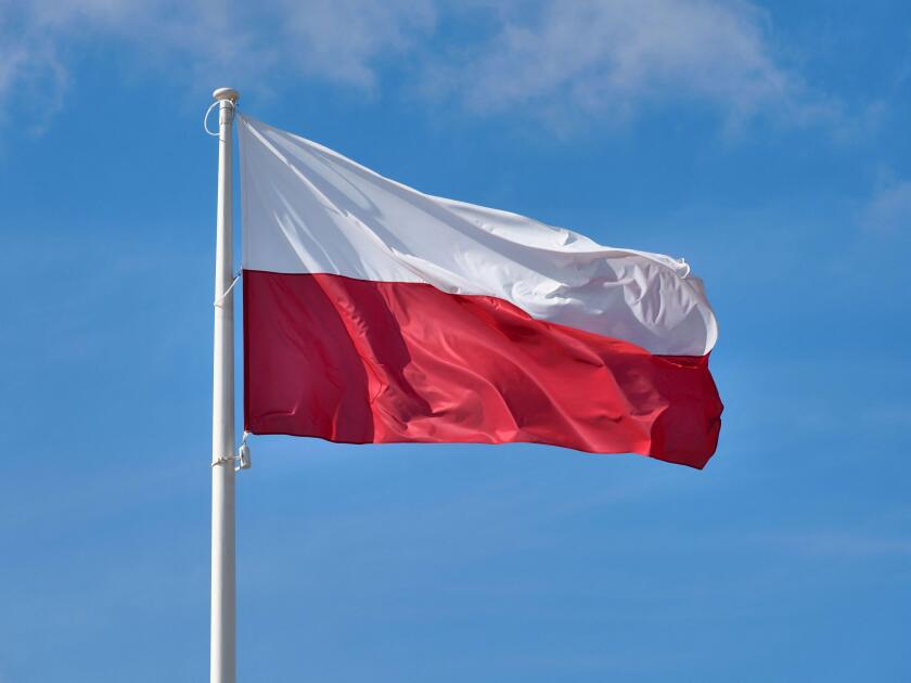 Polish flag against blue sky