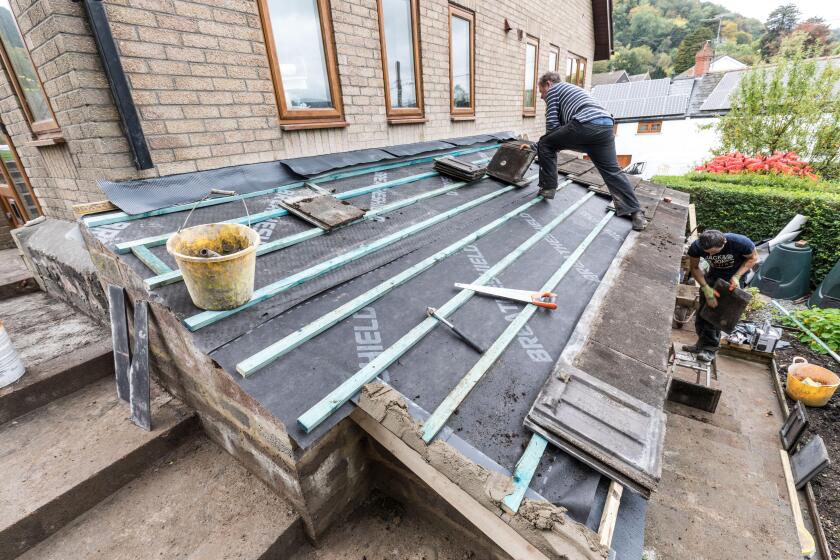 Building roofing house extension, Wales, UK