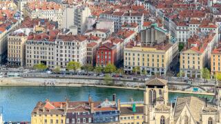 Cityscape of Lyon viewing east from Basilique Notre-Dame de Fourviere. These over the rooftops photos show the River Saone in the foreground.