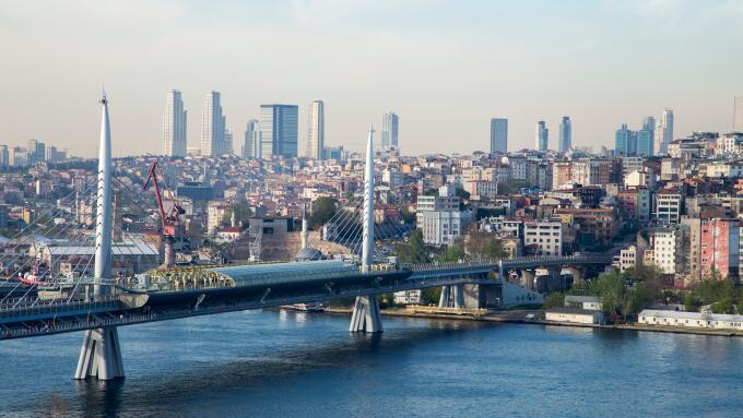 Golden Horn Metro Bridge with old and modern side of Istanbul background view during the day time. Lots of building and sea view
