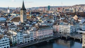 Zurich, Switzerland, Jan. 4, 2026. View of Zurich from Grossmunster tower showing the snowy rooftops, the Limmat river and the St. Peter church