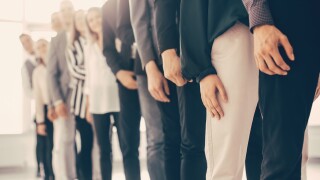 image of young business people standing in a long queue