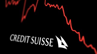 White Credit Suisse logo on a stock market performance chart tre