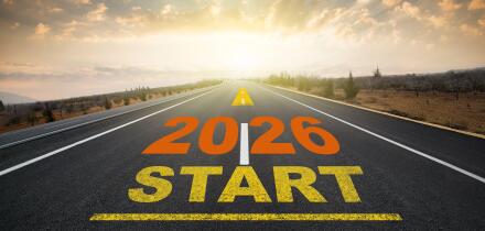 Concept for the start of the new year 2026. The word 2026 written on the asphalt road at sunrise. New calendar year change and anniversary concept