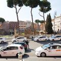 Taxi cars parked in street in Rome, Italy