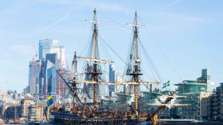 Gotheborg of Sweden, a sailing replica of the Swedish East Indiaman Gotheborg I, visiting London, UK. London city skyline, financial district