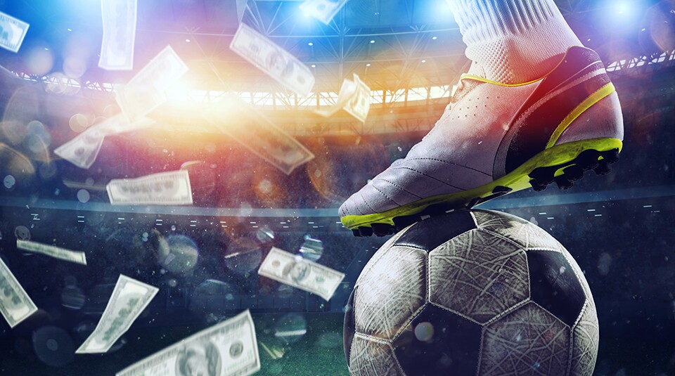 Soccer player in stadium with falling banknotes of bettors