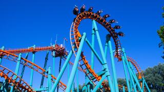 Orange rollercoaster with blue sky in the background