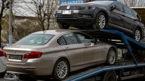 Bucharest, Romania - March 02, 2020: A BMW 520d car and a Volkswagen Passat B8 Highline Variant are transported on a trailer in Bucharest.