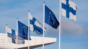Helsinki / Finland - MARCH 6, 2022: Closeup of five flags waving in the wind. European Union flag. Flag of Finland