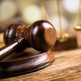 Golden scales of justice, books, Statue of Lady Justice. Owl and