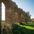 Ancient Roman aqueduct ruins of Aspendos in green spring landscape