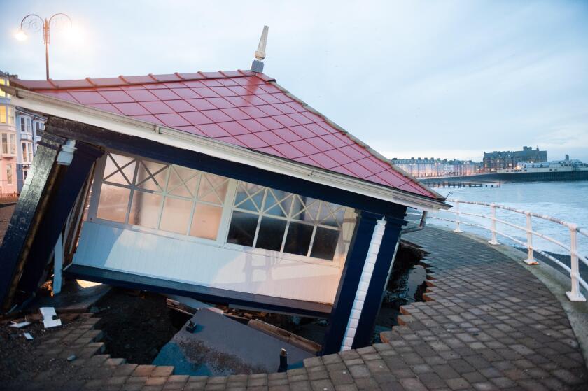 Aberystwyth Wales UK, Tuesday 07 Jan 2014 As the stormy weather subsides, the full impact of several days of huge tides and massive waves becomes clear to see on Aberystwyth promenade, Wales UK. The iconic and historic public shelter lies in ruins as its