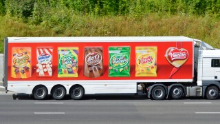 Nestle hgv supply chain delivery lorry truck & articulated trailer colourful advertising display of its  products driving along M25 Motorway Essex UK