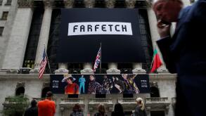 A banner to celebrate the IPO of online fashion house Farfetch is displayed on the facade of the of the New York Stock Exchange (NYSE) in New York, U.S., September 21, 2018. REUTERS/Brendan McDermid
