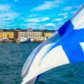 Helsinki skyline from the sea.The Finnish flag is floating. Market Square and Helsinki Cathedral from the sea. The seascape of Helsinki in the summer.