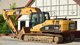 Parked Caterpillar construction equipment (Digger / Excavator).
