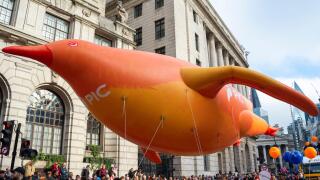 Pension Insurance Corporation float at the Lord Mayor's Show parade in the City of London, UK. Large inflatable penguin floating through City streets