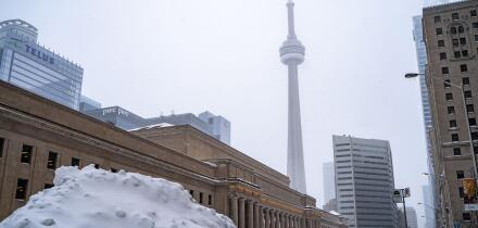 Winter storm view of downtown Toronto. Snow-covered cityscape.