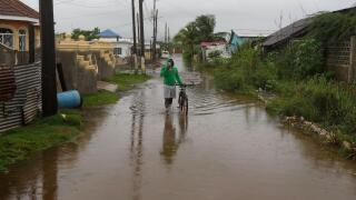 A man wades through a flooded street ahead of the forecasted arrival of Hurricane Melissa in Old Harbour, Jamaica, Monday, Oct. 27, 2025. (AP Photo/Matias Delacroix)