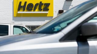 A logo sign outside of a Hertz car rental location in Silver Spring, Maryland on May 23, 2020.