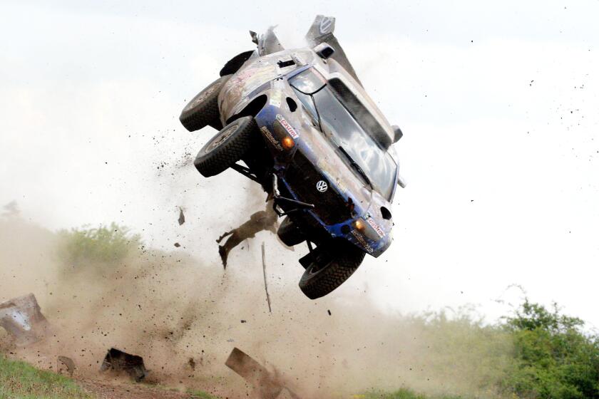 Driving their Volkswagen, Giniel De Villiers of South-Africa and his German co-driver Dirk von Zitzewitz are airborne after they have encountered a series of dirt road bumps hiding behind a steep road section, resulting in a multiple roll-over during the 