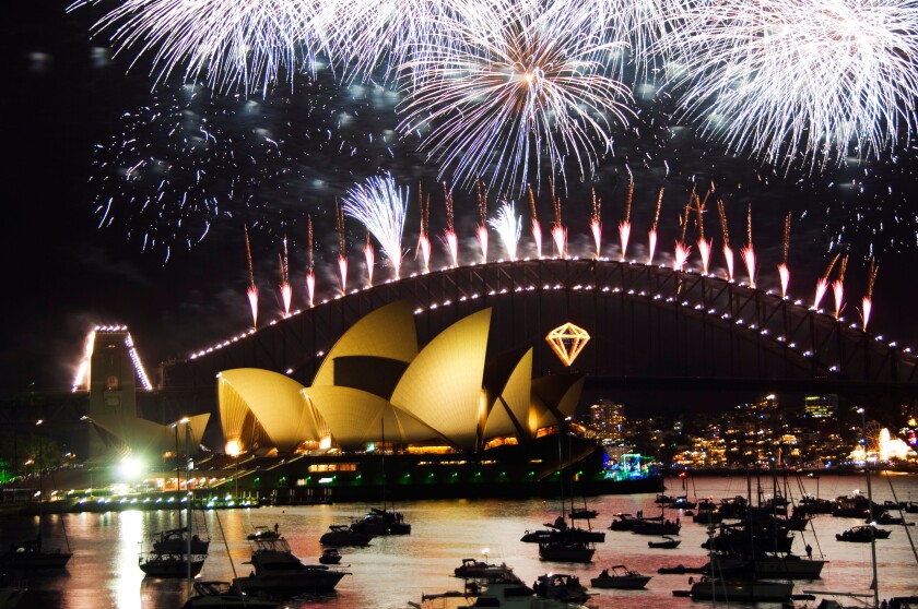 Australia, New South Wales, Sydney. Opera House and Coathanger Bridge with boats in Sydney Harbour - 2006 New Years Eve.