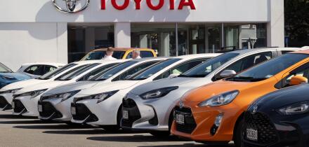 New Toyota vehicles displayed outside dealership showroom in Wellington, New Zealand.
