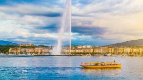 Classic view of Geneva skyline with famous Jet d'Eau fountain at Lake Geneva in beautiful evening light at sunset, Switzerland