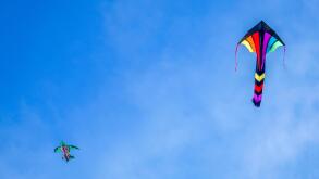 Two colourful kites flying high on sunny day, Brenton Point State Park, Newport, Rhode Island, USA