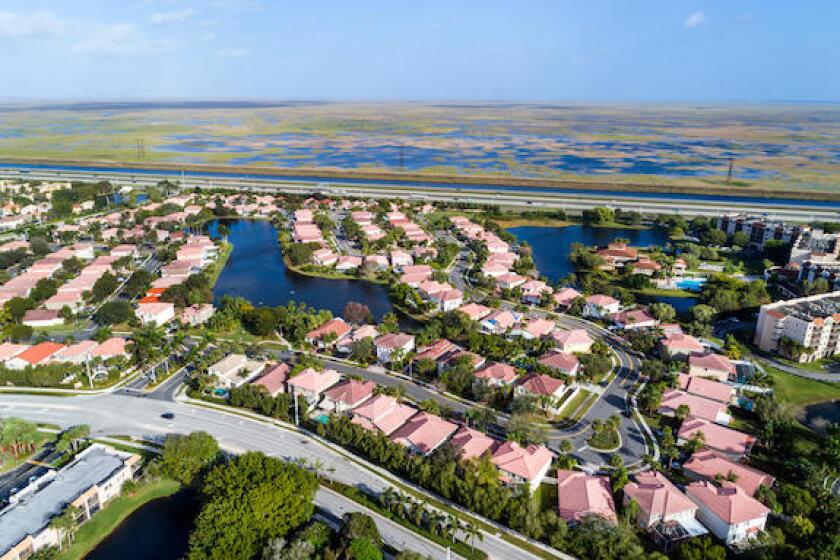 Weston Florida,Fort Ft. Lauderdale,aerial overhead view from above,homes residences bordering Everglades Wildlife Management Area Water Conservation A