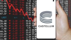 A man holds a smartphone displaying the logo of company Castellum listed on OMX Stockholm. Negative stock market background. Credit: PIXDUCE
