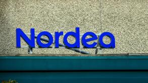 A prominent blue sign displays the name of the bank, Nordea, on the exterior of a well-maintained building, emphasizing its modern design and accessib
