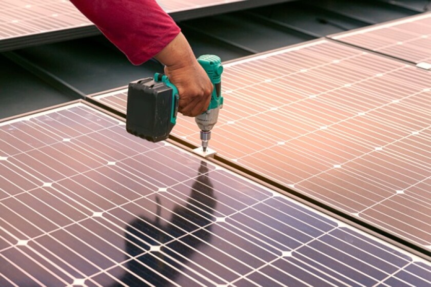 Installing rooftop solar panel from Alamy 22Jul24 575x375