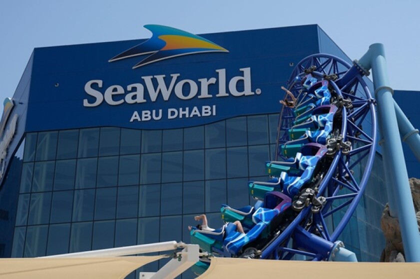 People enjoy riding on a roller coaster at the SeaWorld on Yas Island in Abu Dhabi, United Arab Emirates, on May 26, 2023. It?s the first venture outside the United States for the theme park chain, which had been mired in controversy in recent years over
