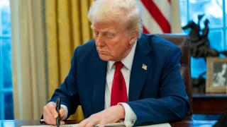 United States President Donald Trump signs two executive orders in the Oval Office of the White House in Washington, DC on Thursday, January 30, 2025. The first order formally commissioned Christopher Rocheleau as deputy administrator of the FAA. The seco