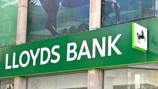 Close up front elevation fascia sign and logos above Lloyds Bank plc branch premises on corner site in London Oxford Street England UK