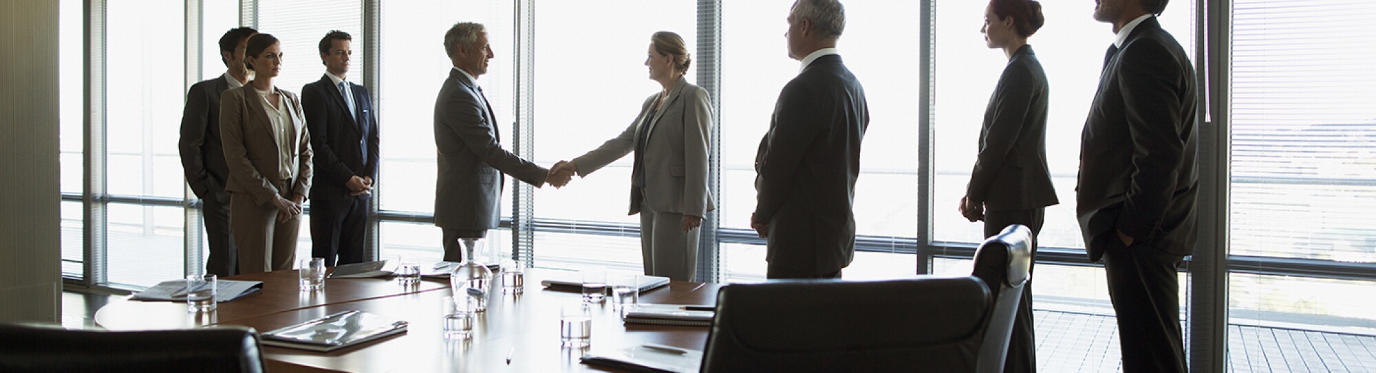 Business people shaking hands in conference room