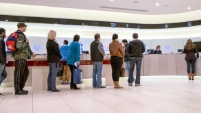 People queuing for counter service inside a high street branch of Barclay's bank UK