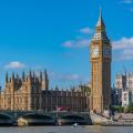 View of Houses of Parliament and Westminster Bridge from Queens Walk during summer in Westminster London England