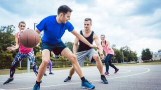 Group of friends are playing basketball outdoors