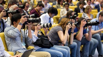 Photographers working in the Press Centre at European Council offices, Justus Lipsius building, Brussels, Belgium.