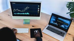 African trader studying stock market at home office - Focus on right hand