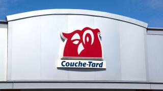 Montreal, Canada - April 4, 2020: Couche-Tard logo on a building over a blue sky. Couche-Tard, is a Canadian multinational operator of convenience sto